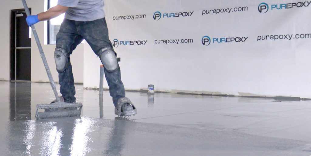man spreading epoxy on the floor